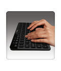 Hands typing on K810 keyboard
