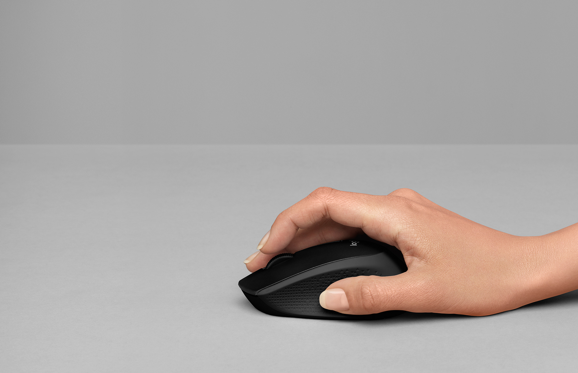 Hand holding logitech m331 mouse