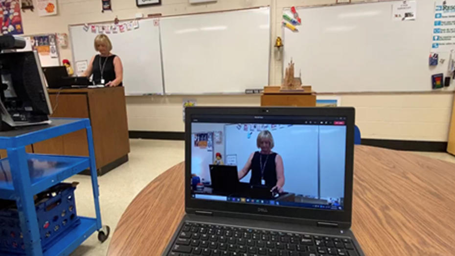 View of student sitting in the class and of one logged into Microsoft Teams