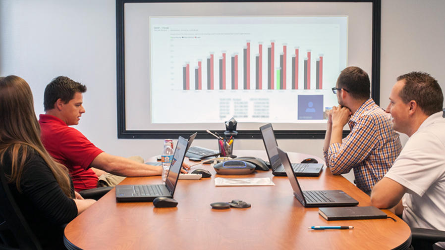 People around video conference table