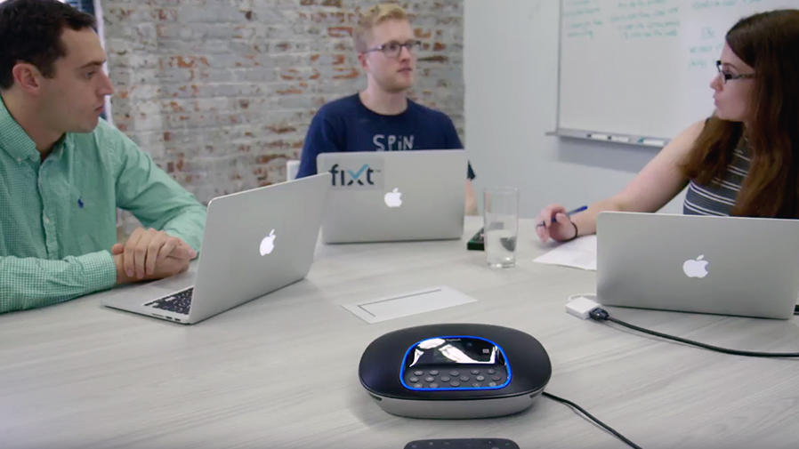 People at a conference table with laptops