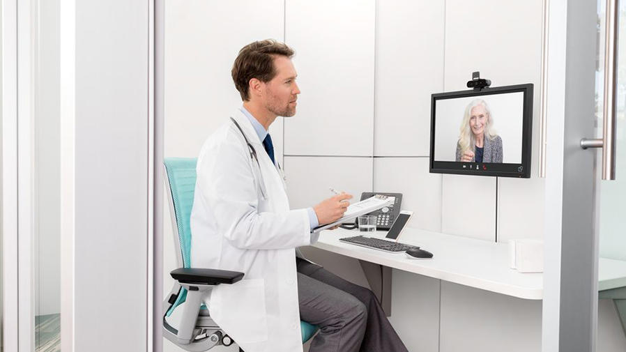Doctor talking to patient via conference cam