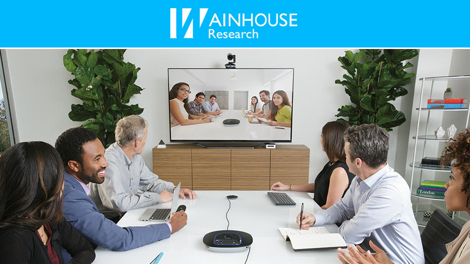People at conference table video conferencing