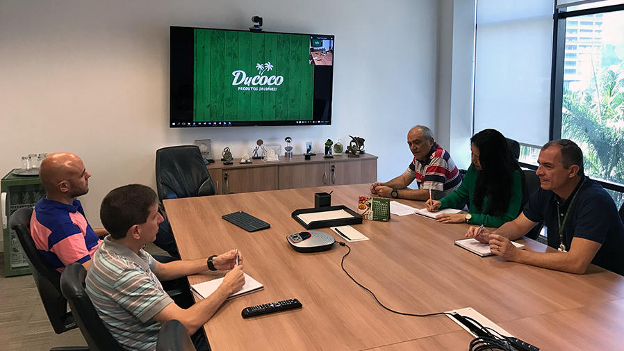 People around video conference table